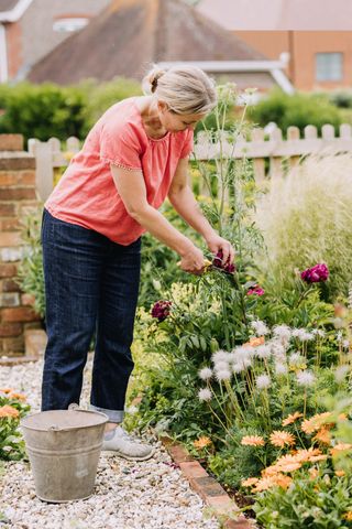 Image may contain Human Person Outdoors Garden Footwear Clothing Shoe Apparel Gardener Worker and Gardening