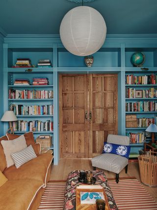 Image may contain Furniture Bookcase Interior Design Indoors Living Room Room Couch Shelf Henri Matisse and Cushion